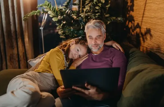 Father and child looking at laptop
